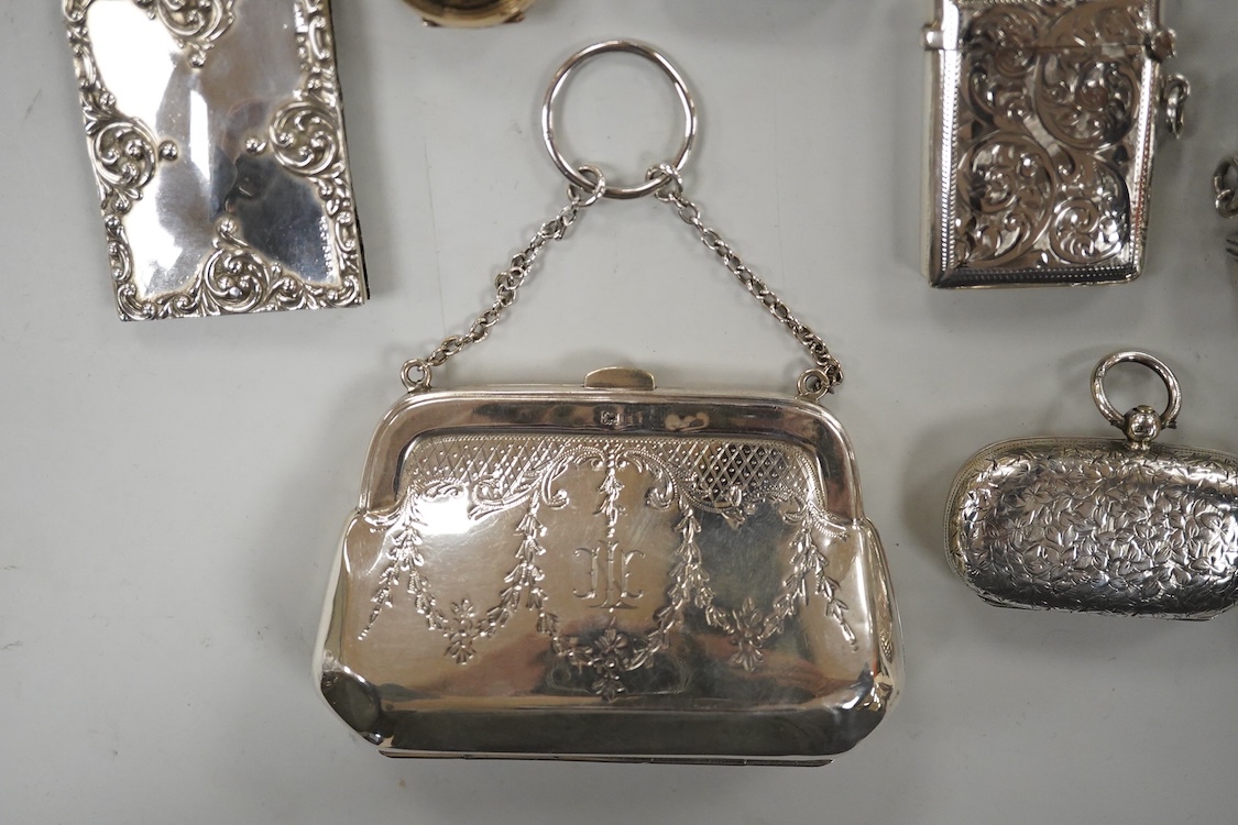 Two late Victorian silver twin compartment sovereign cases, Birmingham, 1891 & 1896, both approx. 57mm, a gold plated sovereign case, together with three silver vesta cases, a silver purse and a silver mounted notebook.